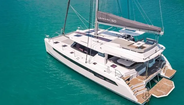 Aerial view of Honey Moon at anchor — upstairs sun deck and forward trampolines visible