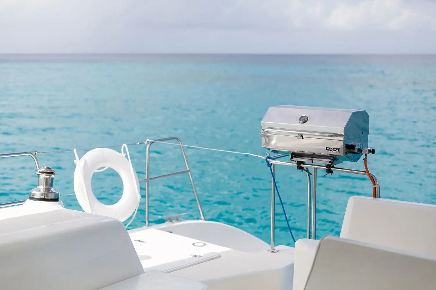 On-board gas grill with turquoise waters