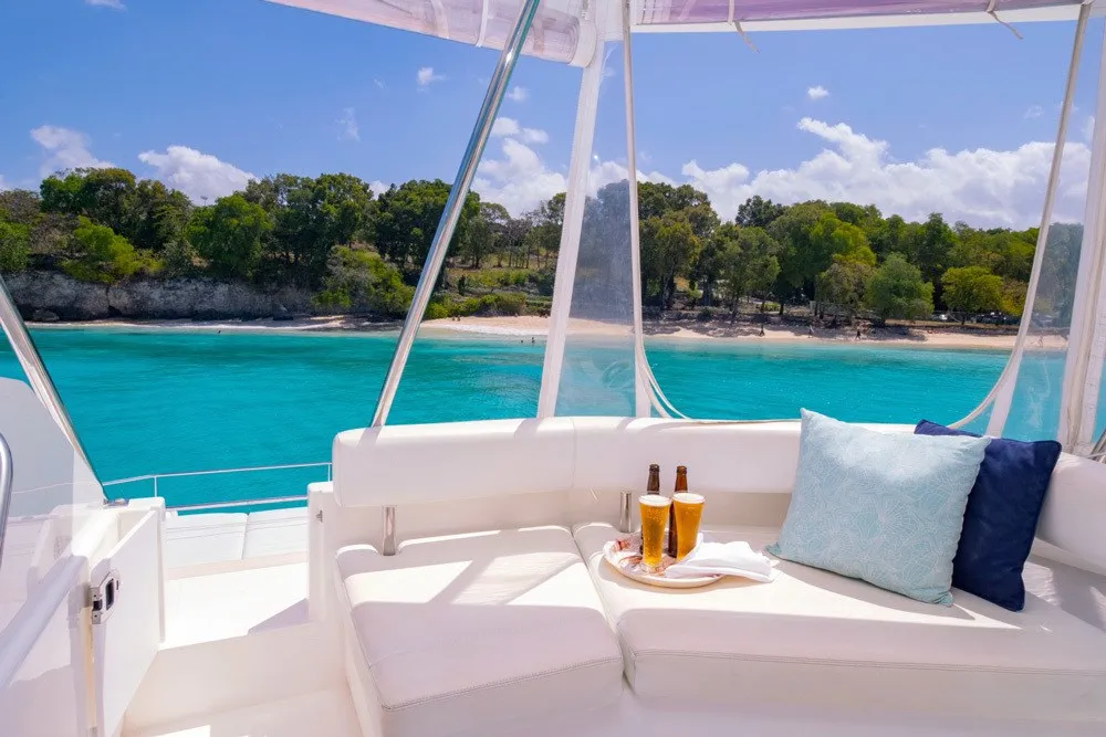Flybridge lounge with cold beers and beach views